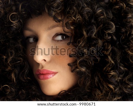 attractive woman with beautiful, thick hair. Woman wearing a huge afro wig. Model in a big afro wig