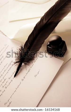 feather quill and inkwell over paper