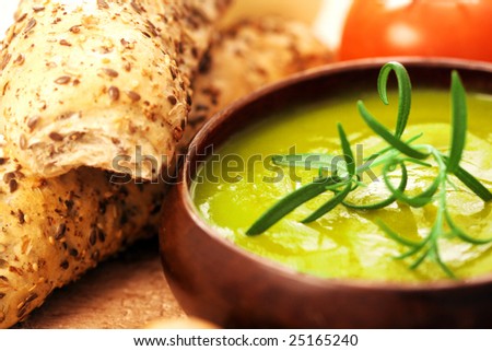 cream of broccoli soup. vevetable soup with rosemary as garnish
