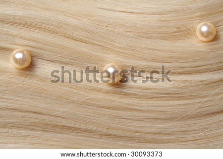 long blond human hair background. pearls