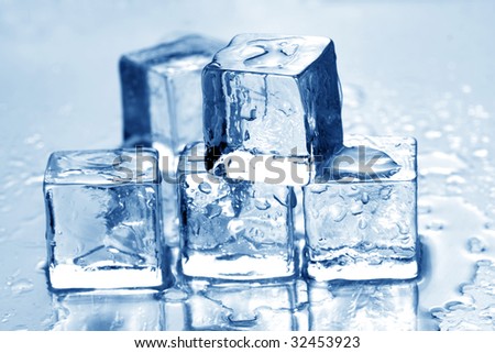 Melting ice cubes on a metal tabletop. blue reflective surface