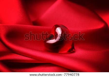 red heart on red silk background