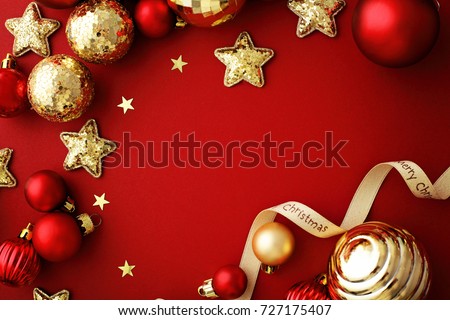 red and gold christmas ornaments, frame with copy space, red background