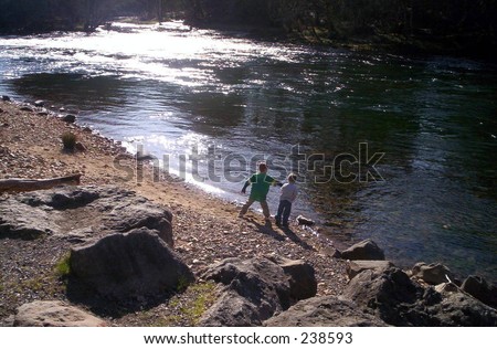 Boys Throwing rocks into the river