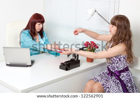 smiling business woman interviewing a young girl