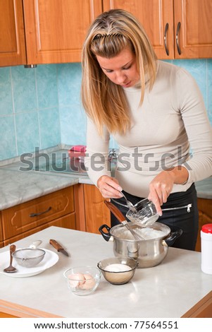 Young woman pours sugar in a pot