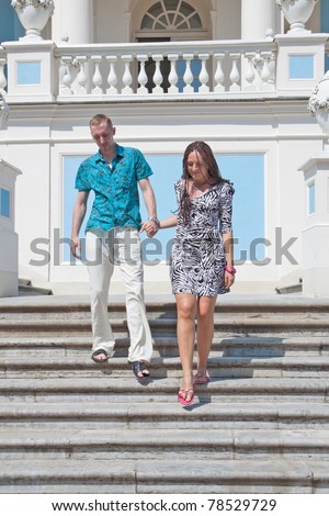 Couple stands on the steps of the ancient palace
