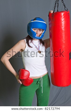 Boxing training woman with punching bag in gym wear gloves