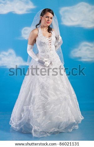 Full-length portrait of bride dressed in elegance white wedding dress