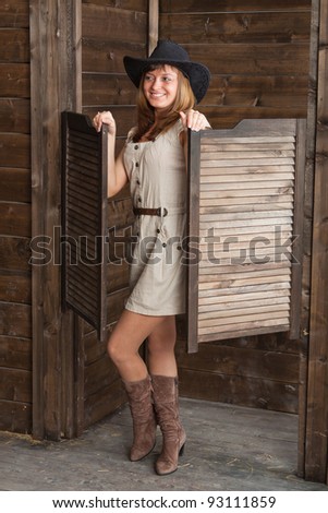 CowGirl standing in saloon entrance