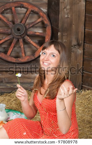 Loves me, loves me not - The girl tells fortunes on a flower camomile