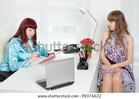 Confident business woman interviewing a young girl