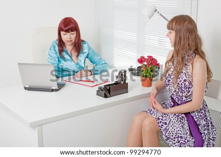 Confident business woman interviewing a young girl