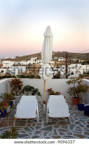 A sun bather\'s paradise on a patio in the Greek Isles.