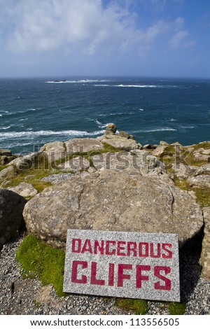 Dangerous Cliffs at Land\'s End in Cornwall, England.  The Longships Lighthouse can be seen in the distance.