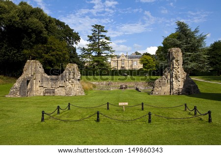 Remains of Glastonbury Abbey with Retreat House in the background.