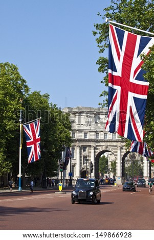LONDON, UK -Â? JULY 9, 2013: A London Taxi drives up The Mall with Admiralty Arch in the background.