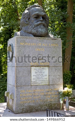LONDON, UK - JULY 6, 2013: Tomb and Statue of Philosopher Karl Marx, marking his resting place in Highgate Cemetery, London.