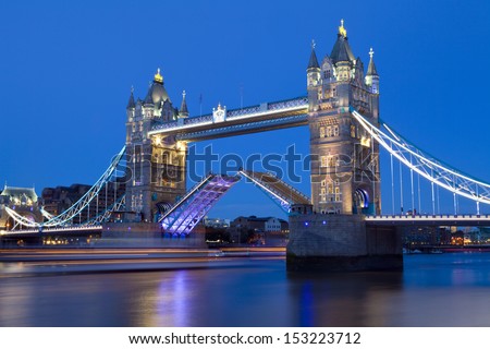 Tower Bridge opens to let a ship pass underneath.