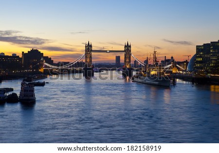 LONDON, UK - MARCH 16TH 2014: London sunrise with Tower Bridge, HMS Belfast and the River Thames in the foreground on 16th March 2014.