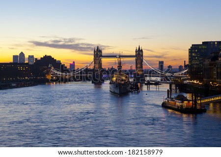 LONDON, UK - MARCH 16TH 2014: London sunrise with Tower Bridge, HMS Belfast and the River Thames in the foreground on 16th March 2014.