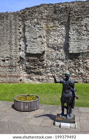 A statue of Roman Emperor Trajan with remains of London Wall which was first built by the Romans in the 2nd and 3rd Centuries AD.