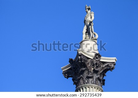 The statue of Admiral Horatio Nelson proudly sitting on top of Nelsons Column in London.