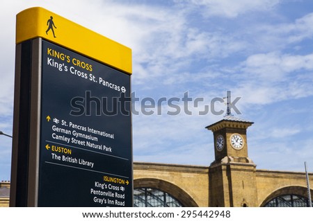 LONDON, UK - JULY 10TH 2015: A pedestrian sign in Kings Cross identifying local places of interest in London on 10th July 2015.  The main building of Kings Cross Station can be seen in the distance.