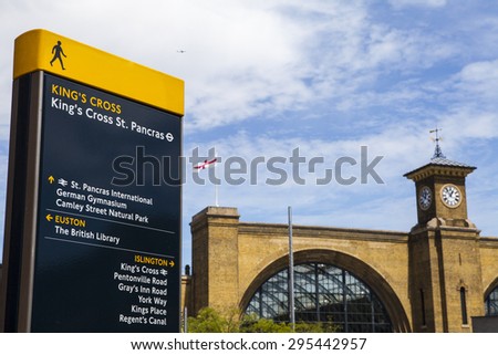 LONDON, UK - JULY 10TH 2015: A pedestrian sign in Kings Cross identifying local places of interest in London on 10th July 2015.  The main building of Kings Cross Station can be seen in the distance.