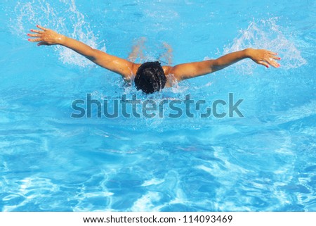 Pretty young female swimmer posing in swimming pool