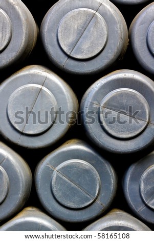 Detail of gray plastic barrels bottoms in factory