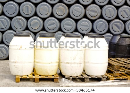 White and gray plastic barrels in factory storage