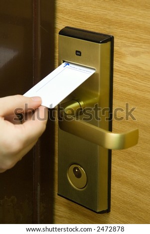 A hand inserting keycard in the electronic lock