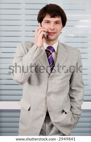 A young businessman calling on the phone
