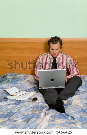 A young man in the hotel working on laptop