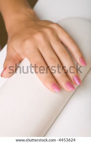 Hand with manicure in the salon