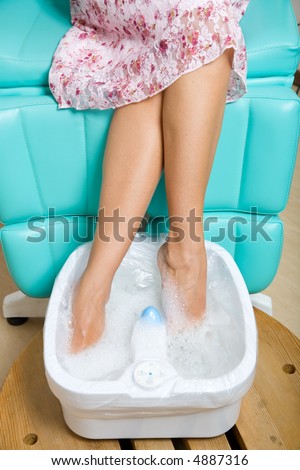 A photo of pedicure process, feet in water