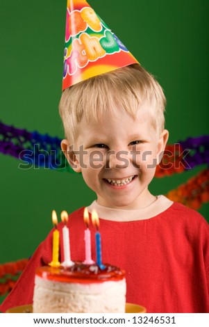 A happy boy on his birthday, making a wish