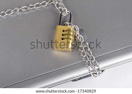 Laptop with chains and combination padlock isolated on white