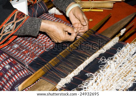 Chinese woman weaving with handcraft loom