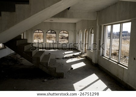 Abandoned house hall with staircase.