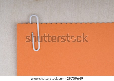 paper clip and blank note on a board