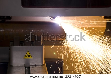 An industrial background Machine, cutting steel tube on the factory