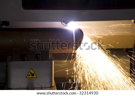 An industrial background Machine, cutting steel tube on the factory