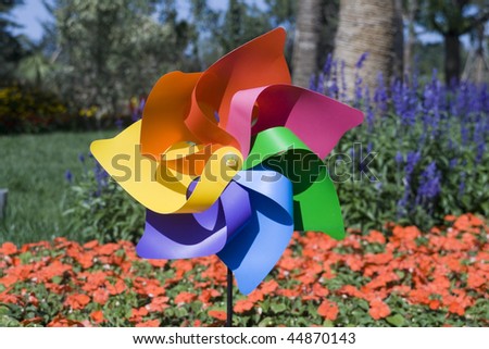 Colorful Toy Windmill in the flowers