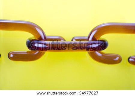 Glass chain links on the yellow background