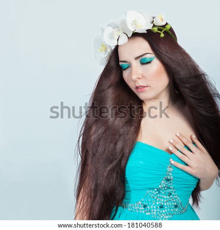 Beautiful Romantic Brunette Girl in Orchid Wreath With Healthy Long Dark Hair, Clear Young Skin.