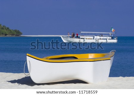 Small yellow and white rowing boat used for landing to desert island, Maldives