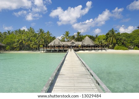 Jetty leading to restaurant and bar overlooking turquoise waters of Indian ocean
