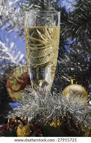 Christmas and New Year decoration, glass of wine and Christmas tree on background